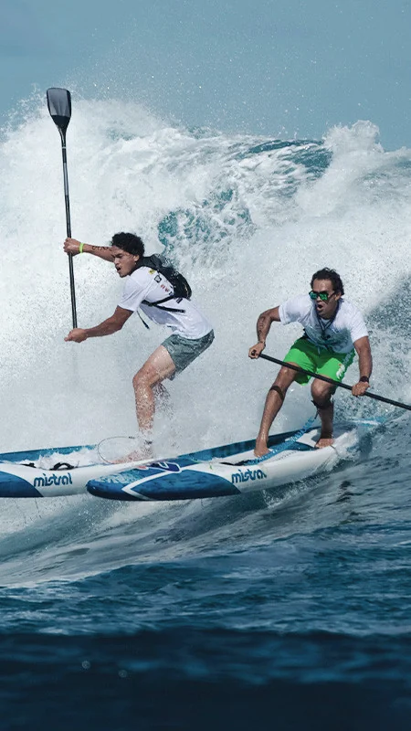 Two men on a sup board on a wave